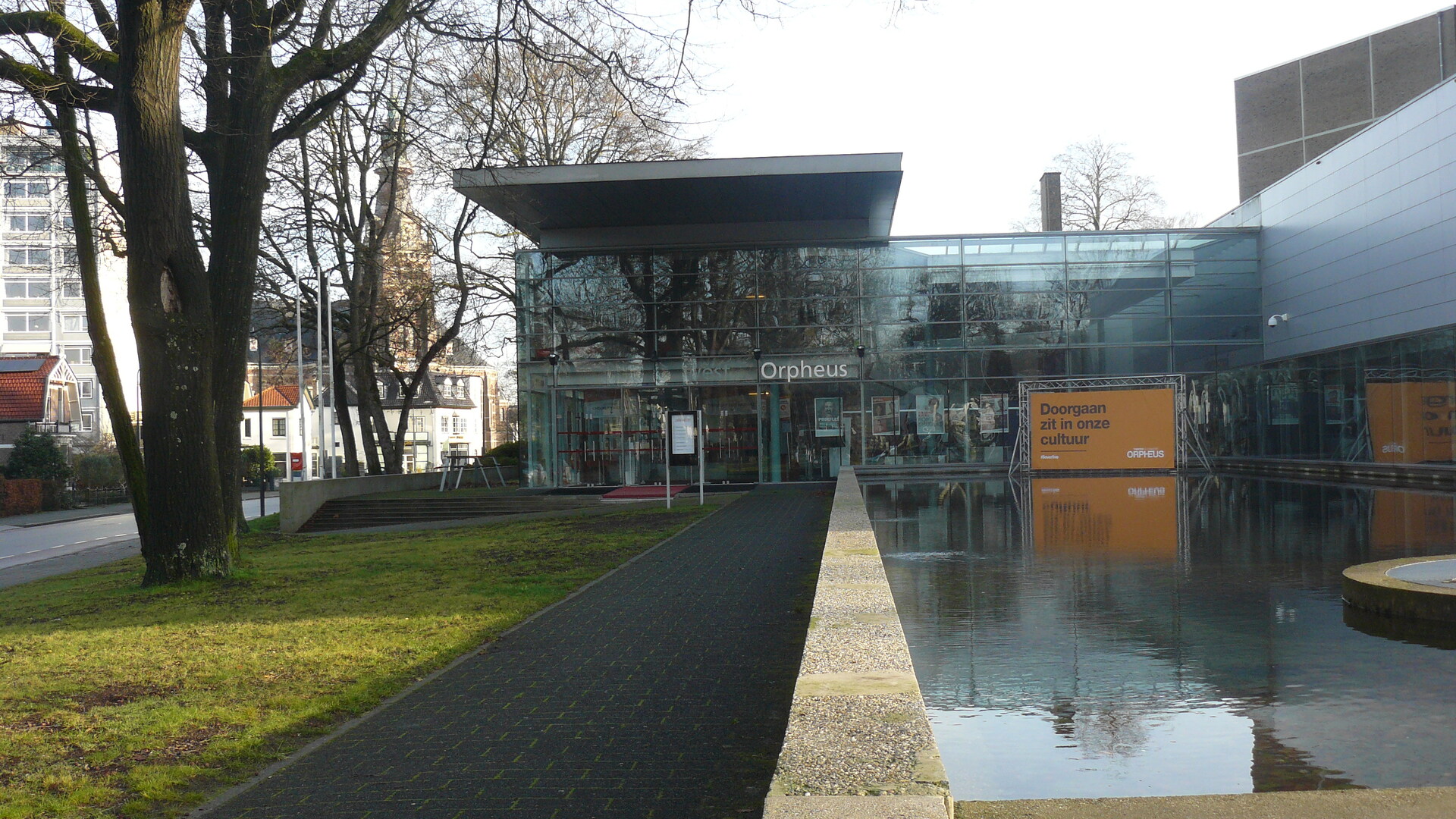 foto van de ingang van Theater Orpheus in Apeldoorn, aan de linker kant een grote boom